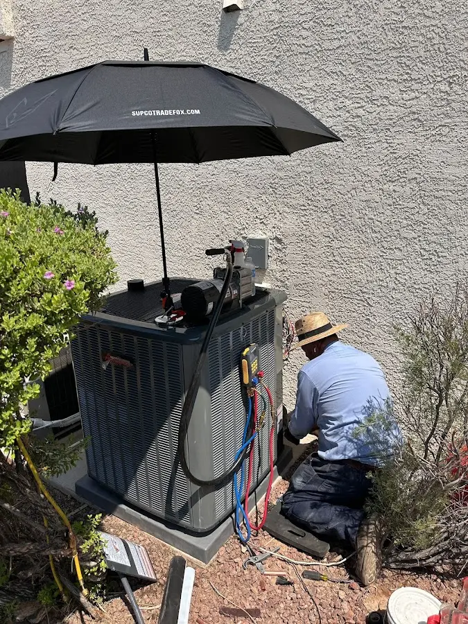 HVAC technician performing outdoor AC maintenance in Eastampton